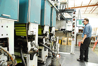 Lead pressman Fred Lopez uses the BCON screen to access a print job on the Chesnut gravure press.