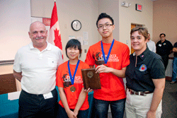 Instructor Peter Belanger (from left) with Sharon Mai and Chong Wang of Gordon Graydon Memorial Secondary School and Bettylyn Kraft of the Phoenix Challenge Foundation.